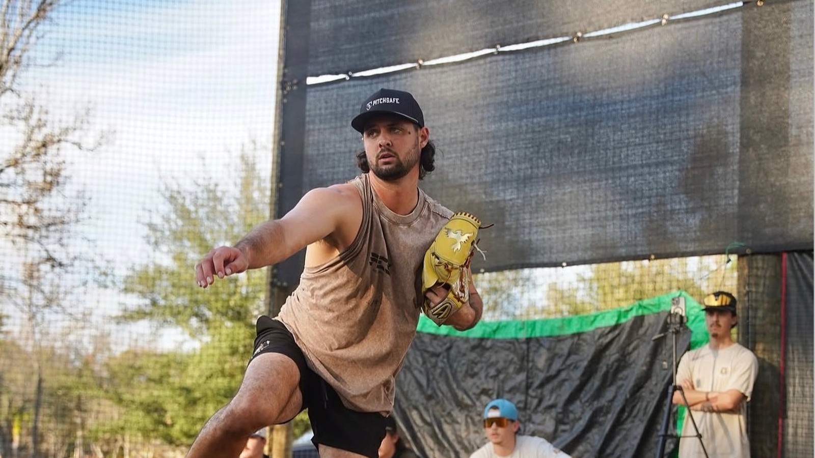 A Den x FCS pitcher mid-delivery on the mound during a bullpen session